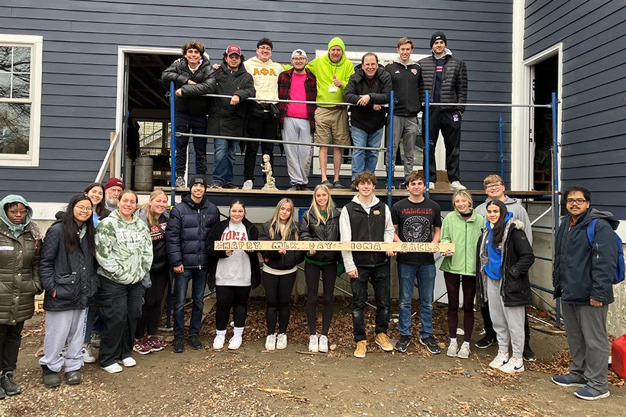 Students volunteer at a house being built by the Fuller Center.