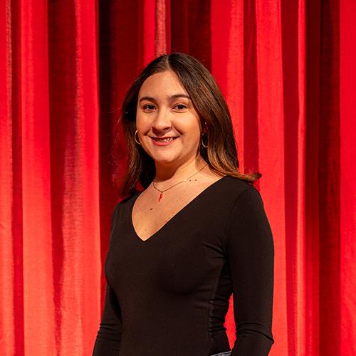 Isabella Ruggiero smiling and posing for a photo on stage.