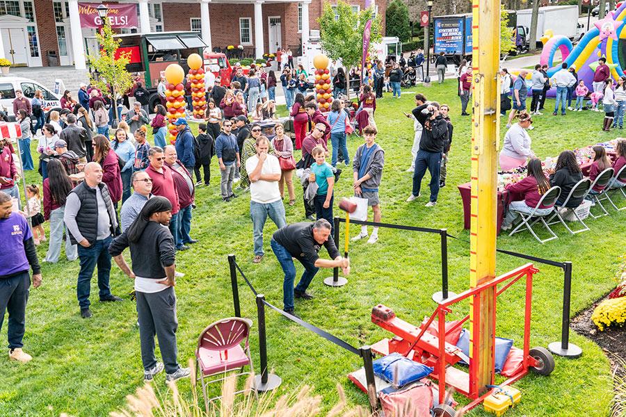Homecoming 2025 fun fair on the Murphy Green filled with tables, booths, games and people.