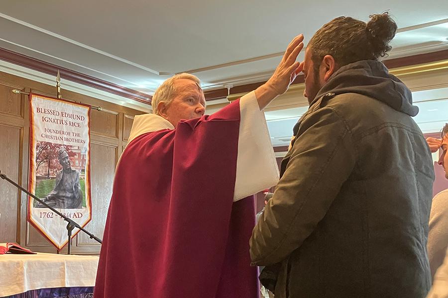 Fr. Mulvey gives ashes on Ash Wednesday.