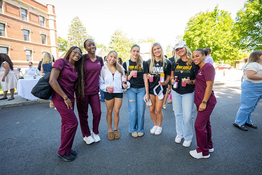 Members of the acrobatics & tumbling team with nursing students at the Bohm Hall ribbon cutting.