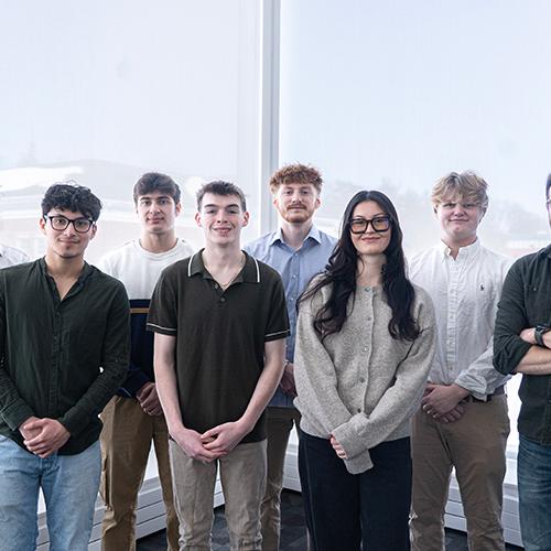 AI Club group photo featuring Professor Robert Kissner and student members.