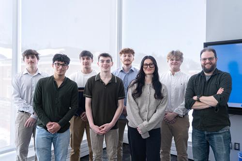 AI Club group photo featuring Professor Robert Kissner and student members.