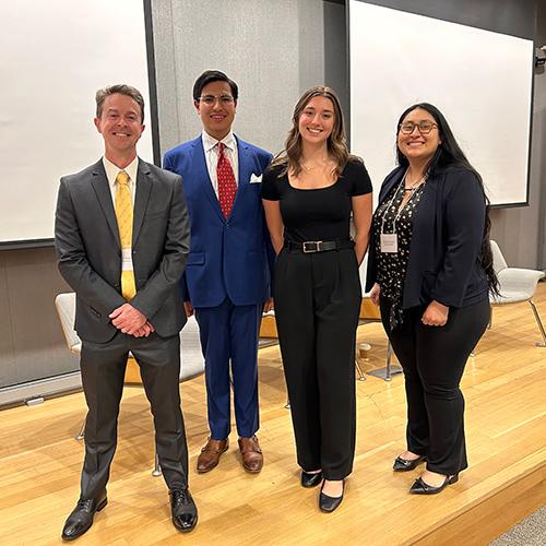 Dr. Hughes with the presenters at the AI conference.