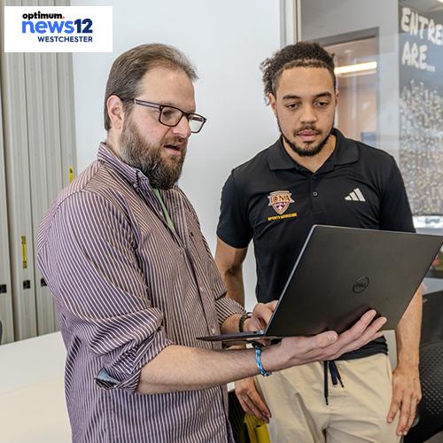 Rob Kissner works with a student in the AI club. 