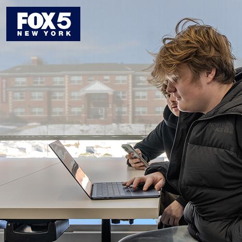 Students work with AI in the classroom.