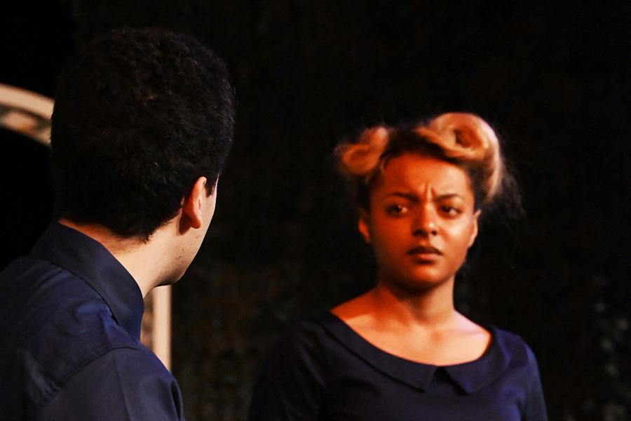 A man speaks to a woman and she looks upset.