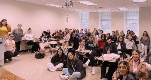 The ASL Club members taking a group photo inside a classroom.