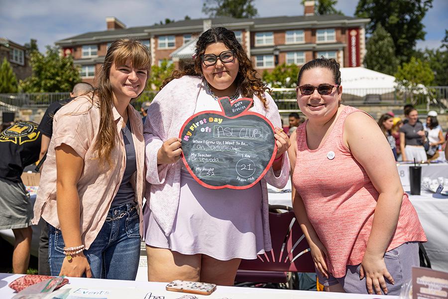 Three members of the ASL club at the Involvement Fair.