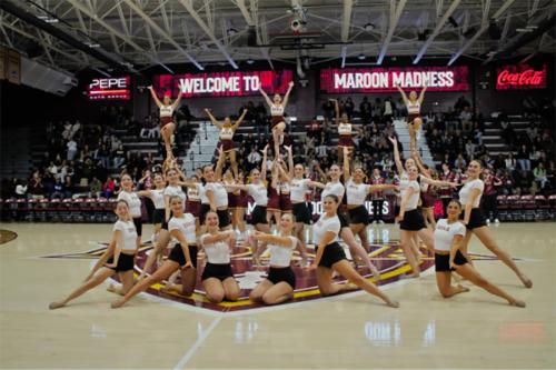 The Cheer Team in formation at a basketball game.