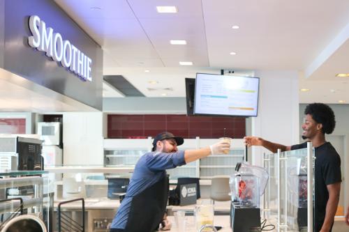 A basketball player receives his smoothie order.