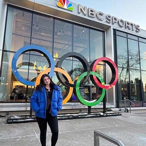 Rebecca Bittner ’28 standing in front of the NBC Sports building.