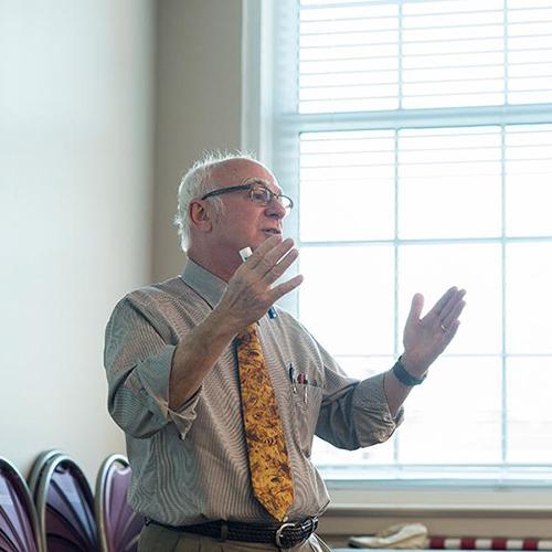 A business professor at the front of the class.