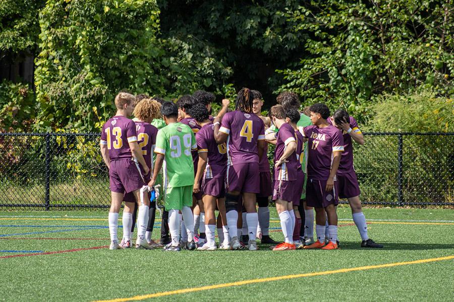 The 2025-26 club men's soccer team huddles up on the field.