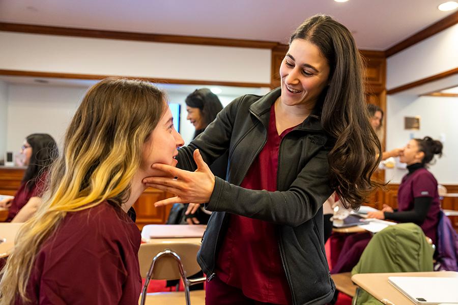 Two CSD students practice vocal chord adjustments.