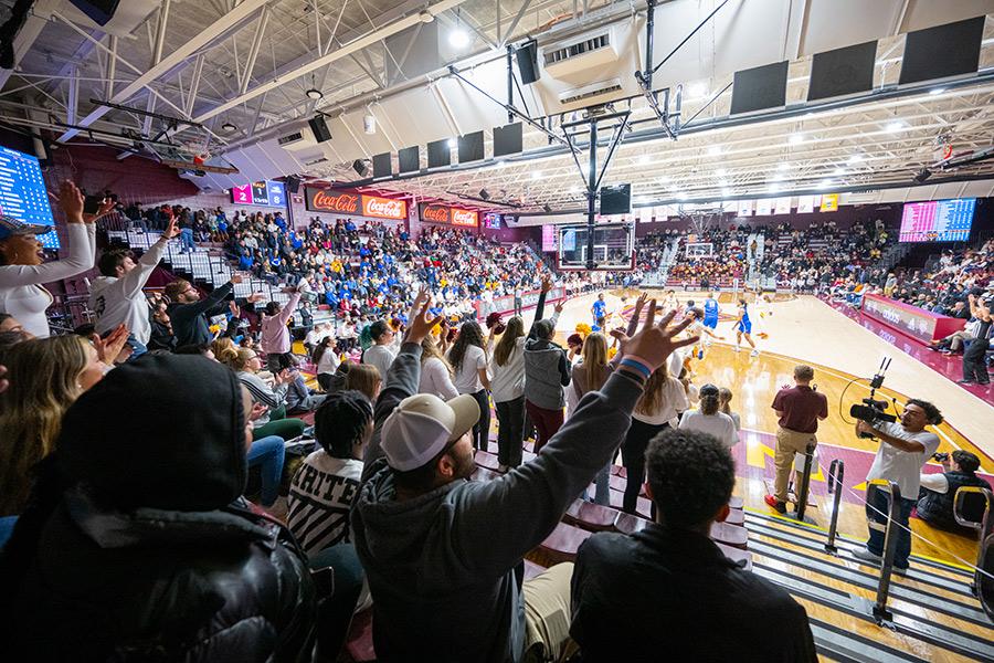 Students cheering and watching Iona University Men's Basketball Team game in the Hynes Athletics Center.