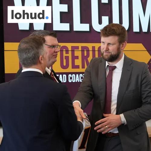 Dan Geriot shakes hands with administration with the lohud logo in the corner.