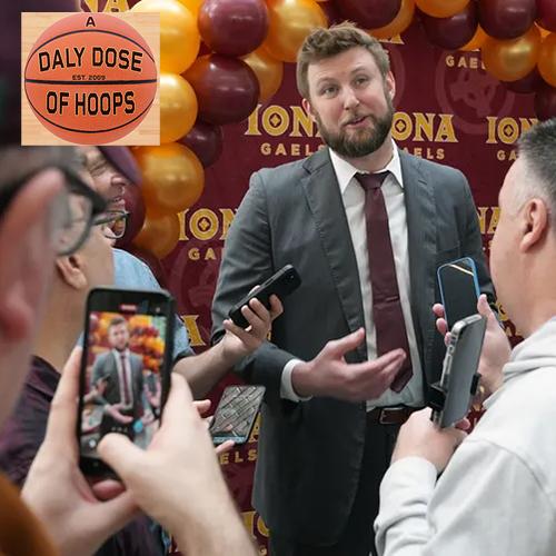 Dan Geriot speaks to the press with A Daly Dose of Hoops logo in the corner.