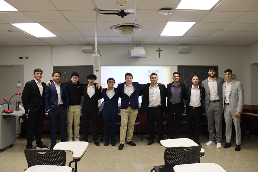 Members of Delta Upsilon in a classroom.