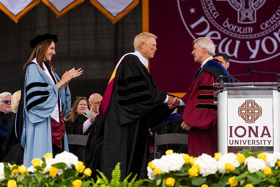 Richard (Dick) Gephardt and President Carey shake hands on stage.