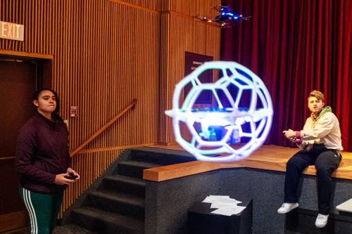 Two students play drone soccer in Murphy.