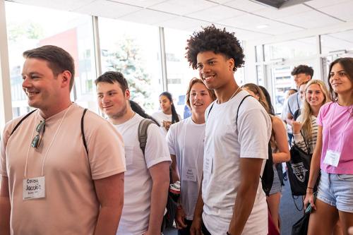 First-year students smile and tour the Athletics center.