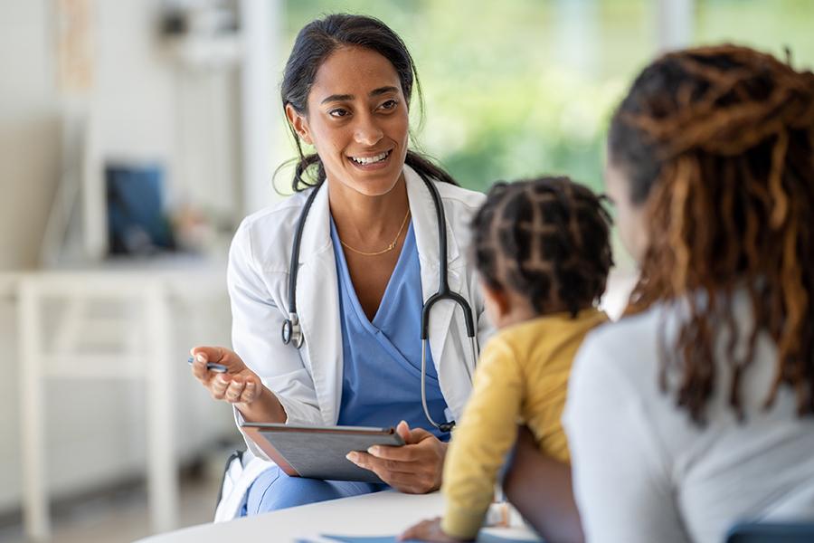 A family nurse practitioner works with a mother and her baby.