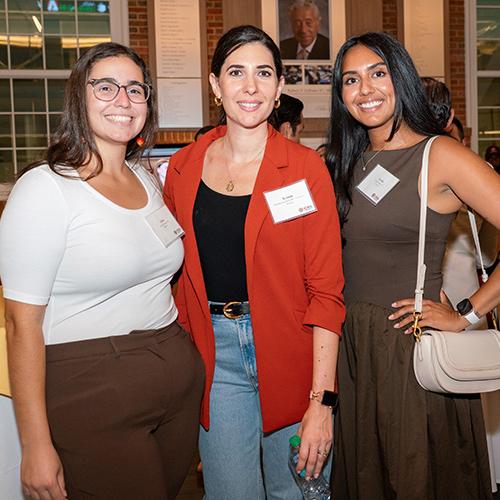 Students and alumni smiling and posing for a photo at the Gaels Go Further 5 Year Anniversary.