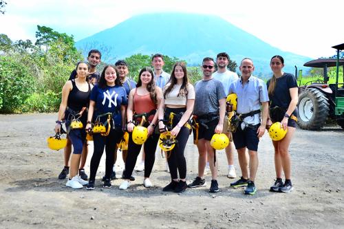 Iona students in Cost Rica with a mountain view in the background.
