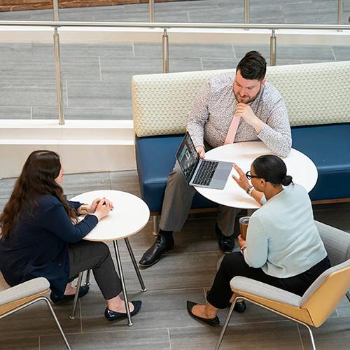 Three students study together in the LSB atrium.
