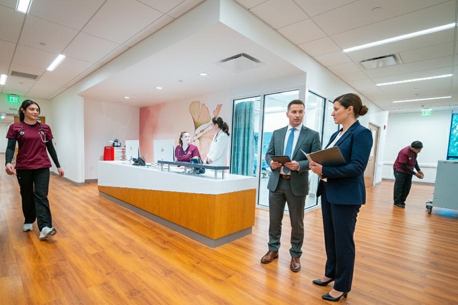 Two healthcare managers in a hosptial setting.