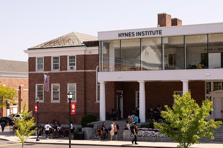 The Hynes Institute with students walking by on the sidewalk.