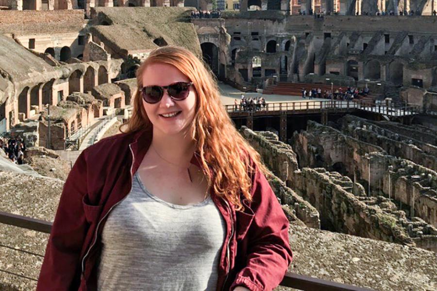 A student stands in the Colosseum in Rome, Italy.