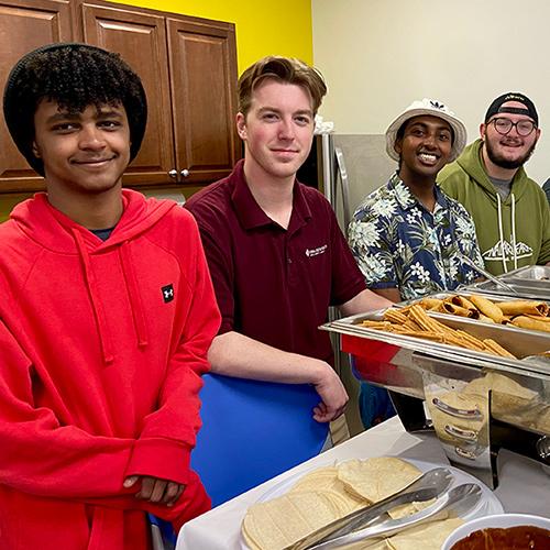 The Food Recovery team at a buffet of food that they will recover.