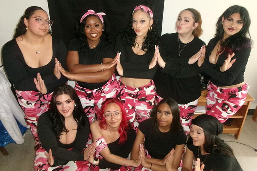 Members of Phi Gamma Chi criss cross arms and smile.