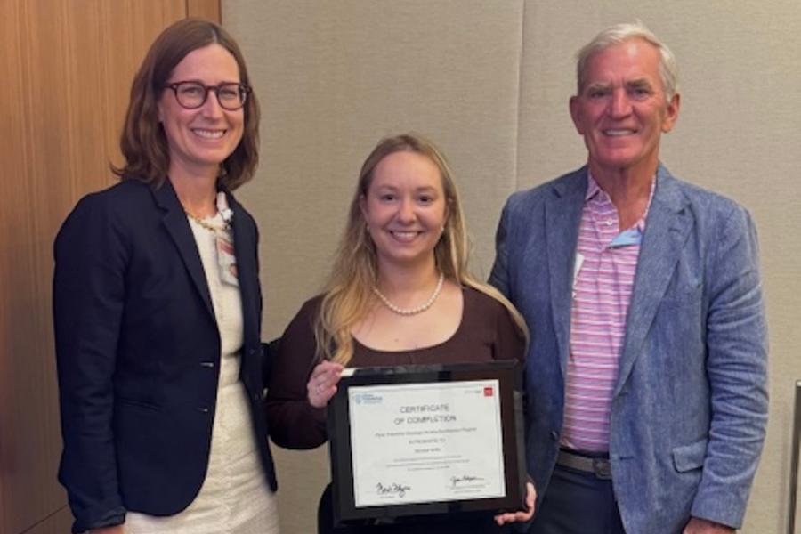 Hannah Griffin '26 posing and smiling holding up the completion certificate of the prestigious Flynn Oncology Fellowship.