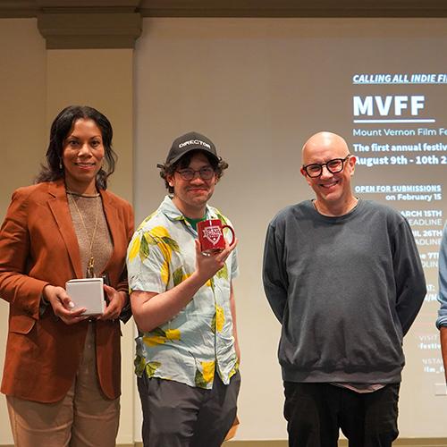 Judges with a student filmmaker at the film festival.