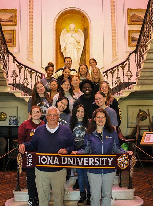 The first Iona Ireland cohort holding an Iona scarf.