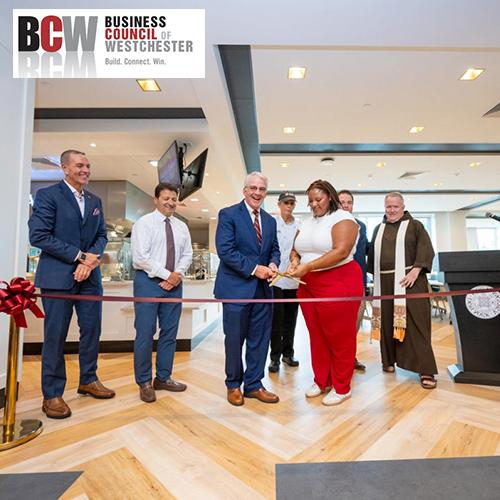 The Iona dining hall ribbon cutting with the BCW logo.