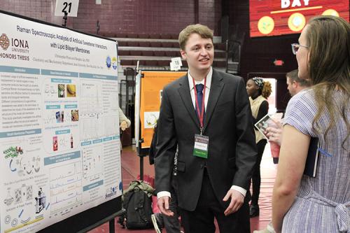 A student explains his findings at Scholars Day.