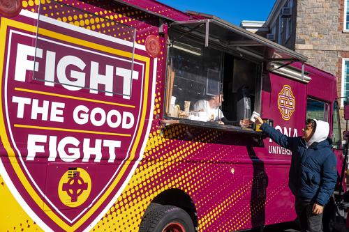 A student grabs a coffee at the Killian's Kitchen food truck.