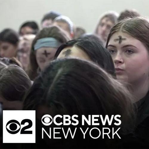 Students with ashes at the Lenten Mass with the CBS logo.