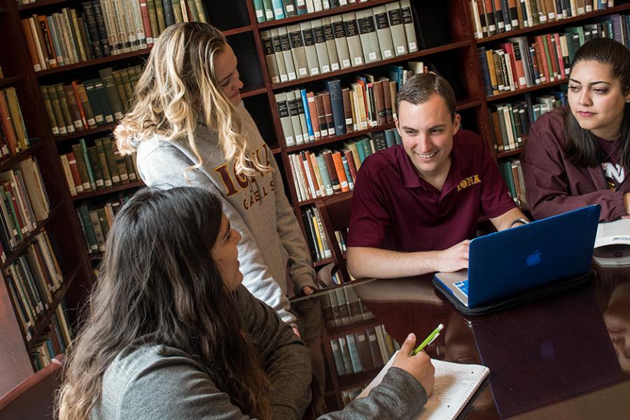 A group of English major students study together at the library.