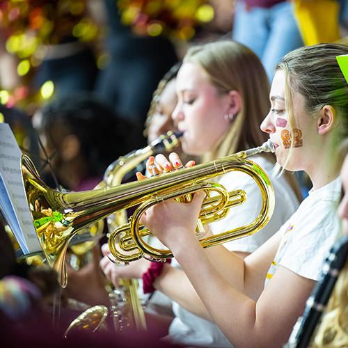 A student in the Pep Band plays the trumpet.