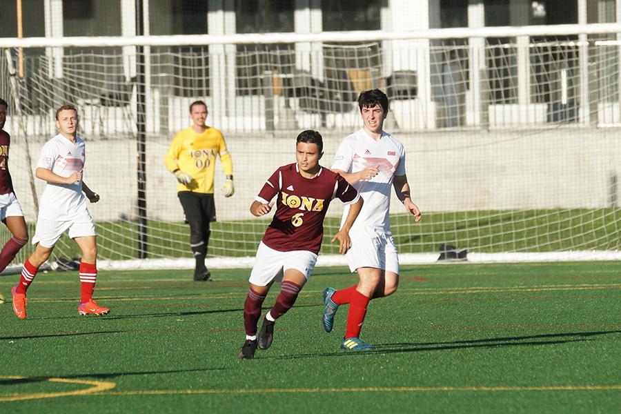 The men's club soccer team drives down the field.