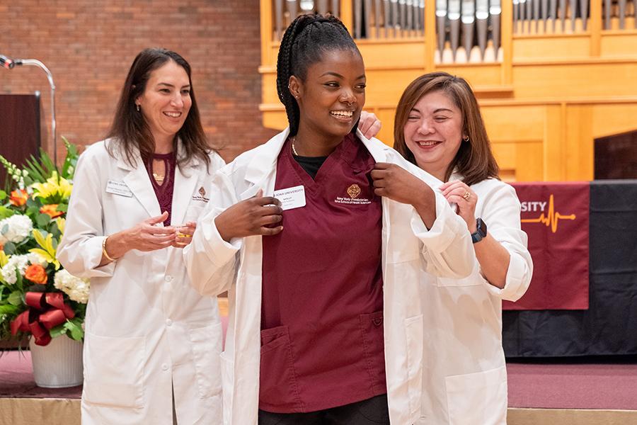 Molly Guillaume with faculty at the NewYork-Presbyterian Iona School of Health Sciences during her White Coat Ceremony in September 2023.