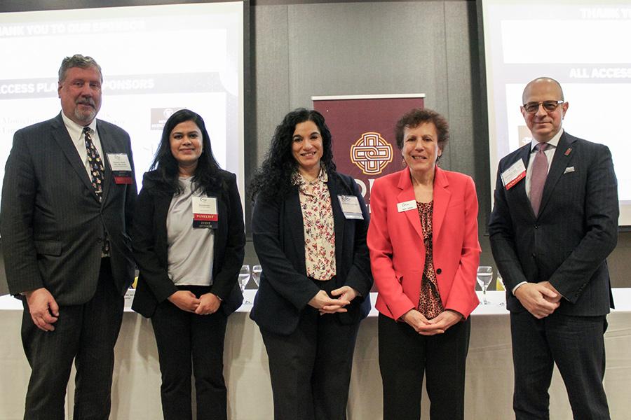 Kavita with the panelists in the Henry Lecture Hall.