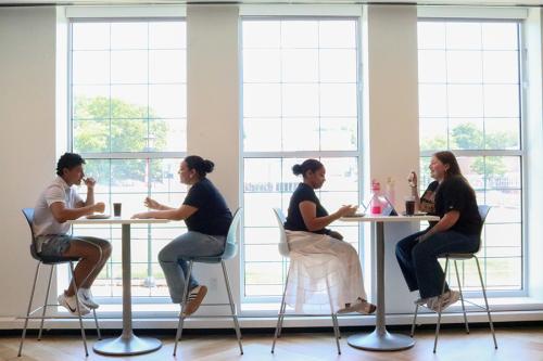 Students enjoying lunch by the windows in the new dining hall.