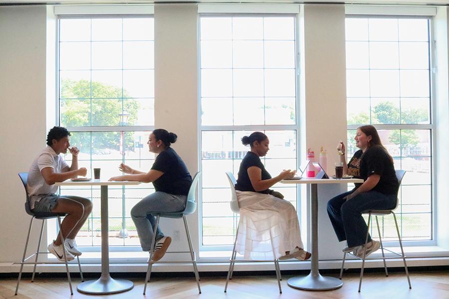 Students enjoying lunch by the windows in the new dining hall.