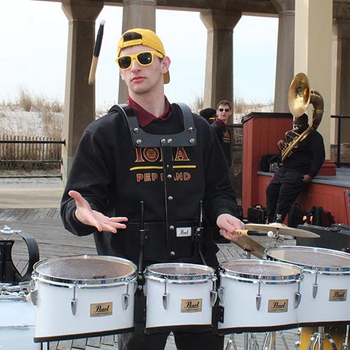 The pep band percussionist flips his stick on the boardwalk in Atlantic City.